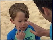 Sam MacFadden and Anthony putting on sunscreen