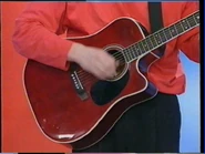 A red Takamine acoustic guitar transition
