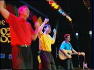 Murray, Greg and Anthony playing yellow Takamine acoustic guitar