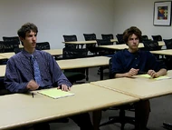 Detective Awesome and Walter Disaster learn about the murder in an office meeting.