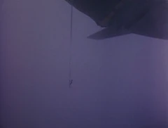 John is lowered onto the deck from Thunderbird 2