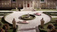 The thieves and Alan driving around the front of the manor, both cars stop starting as neither can drive