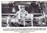 No. 9 Hood in one of his many disguises places an auto-bomb in the hydraulic landing gear of the world's fastest airliner "Fire Flash"