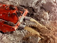 As the drill enters the cave water pours out through the ducts