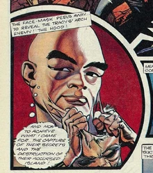 The Hood rips a mask off his face, leaving behind strands of material