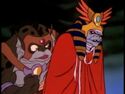 Mumm-Ra in his Egyptian-type cloak, trailed by Slithe.