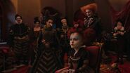 Tarrant putting another hat on the Red Queen.
