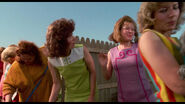 Peg having the ladies stay in single file line as they wait to get their dogs groomed by Edward.