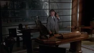 Batman-movie-screencaps.com-1710.jpg (214 KB) Grissom at his desk about to make a phone call.