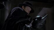 When Napier's second-in-command Bob holds Gordon at gunpoint, Batman is forced to let Napier go.