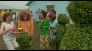 Peg showing her neighbors the topiaries.