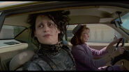 Peg driving her car as Edward is fascinated with his new surroundings.