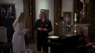 Vicki telling a valet of a reservation she has with Bruce Wayne.