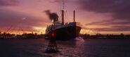 The ship leaving port at dusk.