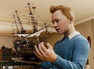 Tintin with his model of The Unicorn