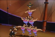 Plucky climbs to the top of a human pyramid
