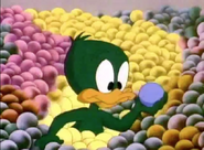 Baby Plucky recovers his blue ball from an avalanche of golf balls