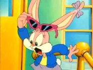 Babs in a blue jacket and red sunglasses