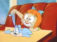 Elmyra plays with a rabbit puppet