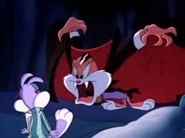 Babs, dressed as a vampire, tells Duncan Potter a scary story