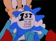 Buster's blue ribbon reads, 1st Exhibit To Be Done Over