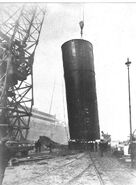 One of Olympic's funnels is lifted up to be installed on the ship