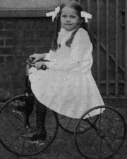 Nina Harper on a tricycle
