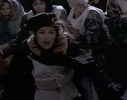 This women is seen running with the crowd towards the stern