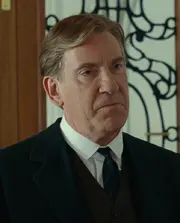 Spicer Lovejoy looking at Jack, sending him away from the entrace to the Dining Room.