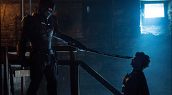 Deathstroke pointing his sword at Jason