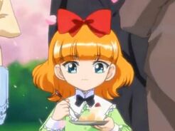 Kanna as a child eating cake at the Aizawa family's tea party.