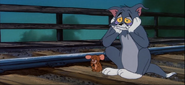 Tom and Jerry waiting for the train in despair