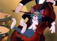 Tom getting bowed by a cellist on a broken cello