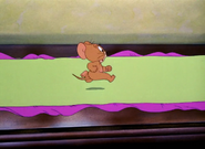 Jerry tries to run across a tablecloth.