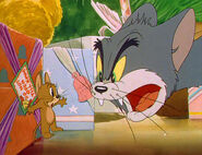 Tom confronts Jerry, moments before the mouse attaches a "Do Not Open 'Til Xmas" sticker to Tom's mouth