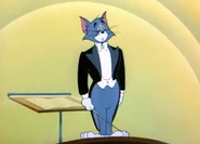 Tom arrives on stage