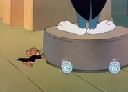 Jerry pushing away Tom's podium with wheels