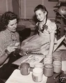 Child actress Margaret O'Brien observing assistant artist Roberta Ritchey preparing a color test for the cartoon. O'Brien was a guest of producer Fred Quimby at the Metro-Goldwyn-Mayer cartoon studio during the time of production.
