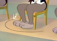 Jerry sawing a circle below a violinist