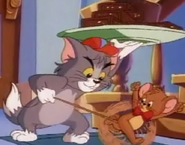 Tom retrieves brownies from Jerry