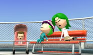 A family of Miis asleep on a bench, with their baby nearby.