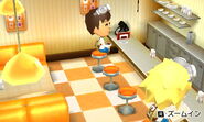 A traveling Mii child visiting the Café.