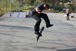 Skater is performing heelflip.
