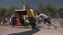 A tuk tuk sets off at the start of hill climb
