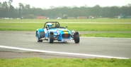 Stig takes power lap for Caterham 620R before crossing finish line.