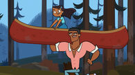 Priya being carried in the canoe by Caleb.