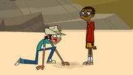 Cameron places a fedora on Mike's head.