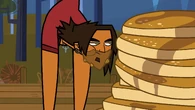 Alejandro is the first person on his team to eat the pancakes...