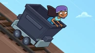 Priya slides down in a minecart.