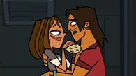 Alejandro and Courtney share a cookie with each other.